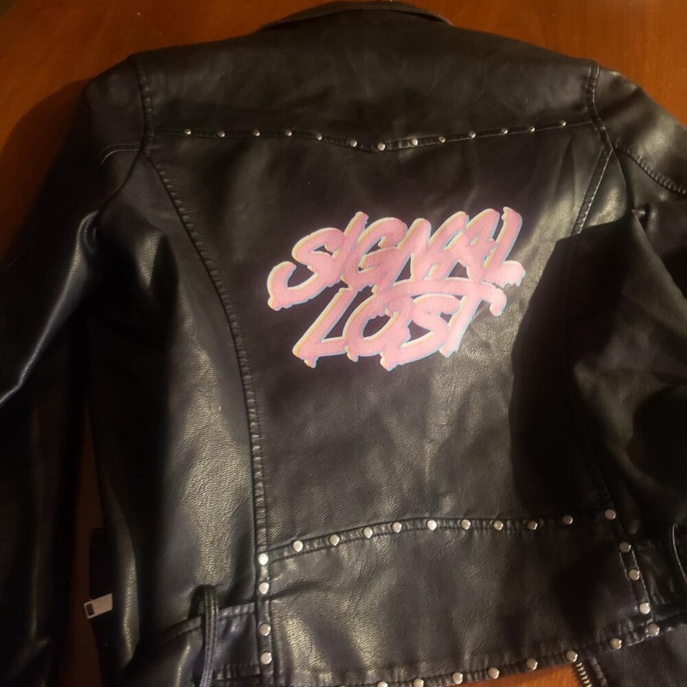 Ladies Faux leather jacket with nice graphic hit on back size M